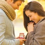 Marriage proposal with a red ring box from a custom jewelry store.